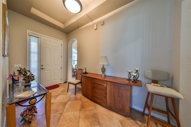 foyer entrance with a tray ceiling