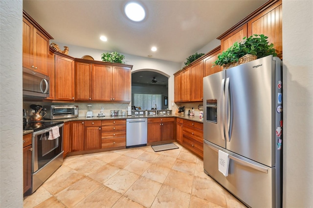 kitchen with ceiling fan, decorative backsplash, sink, and appliances with stainless steel finishes