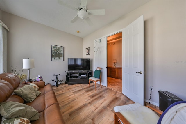 living room featuring ceiling fan and light wood-type flooring