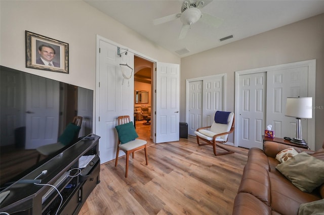 living room featuring light hardwood / wood-style floors and ceiling fan