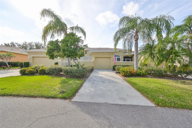 view of front of home with a front yard and a garage