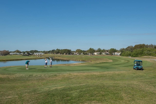 view of home's community with a yard and a water view