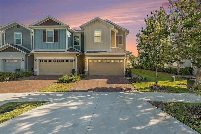 craftsman-style house with a garage and a yard