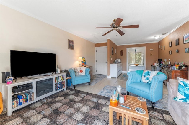 tiled living room featuring ceiling fan and ornamental molding