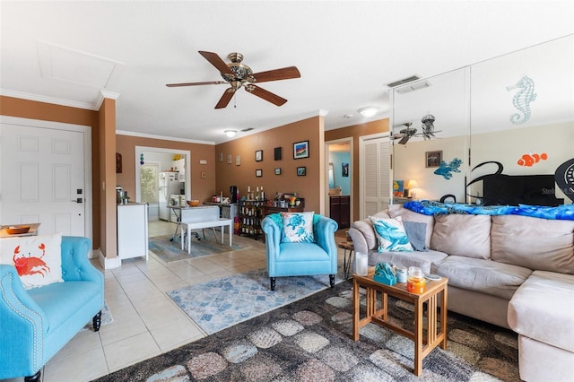 tiled living room with ornamental molding and ceiling fan