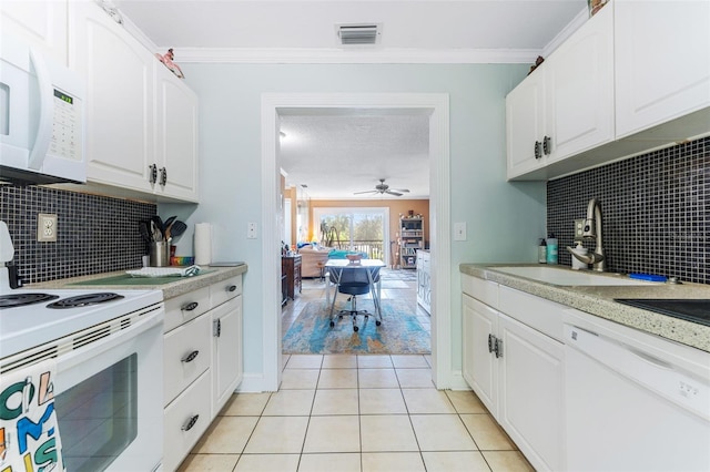 kitchen featuring light tile patterned flooring, sink, ornamental molding, white appliances, and white cabinets