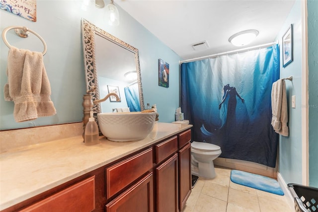 bathroom featuring toilet, walk in shower, vanity, and tile patterned floors