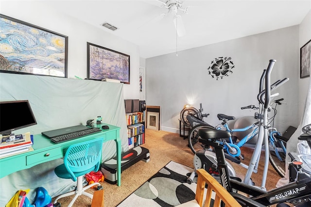 exercise room featuring ceiling fan and carpet floors