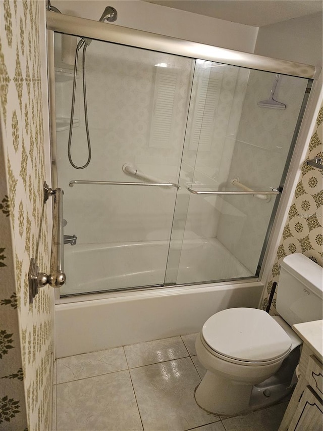 full bathroom with vanity, tile patterned flooring, combined bath / shower with glass door, and toilet