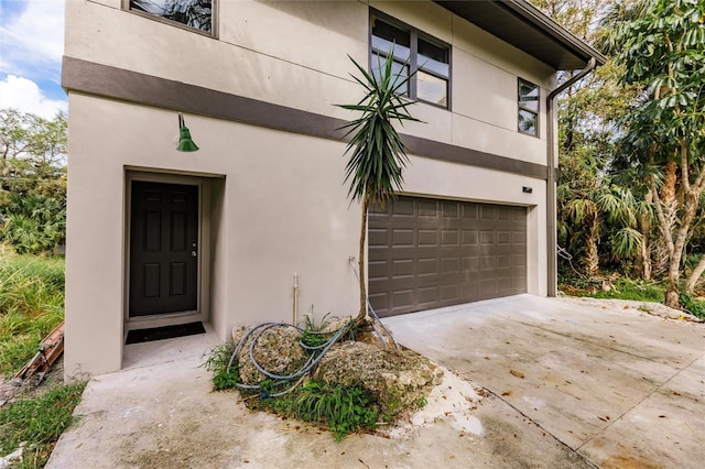 21048 Peachland Blvd, Port Charlotte, FL 33954 - entrance to property with a garage, stucco siding, and driveway