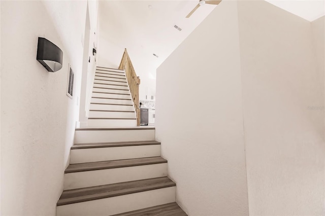 staircase with hardwood / wood-style floors and lofted ceiling