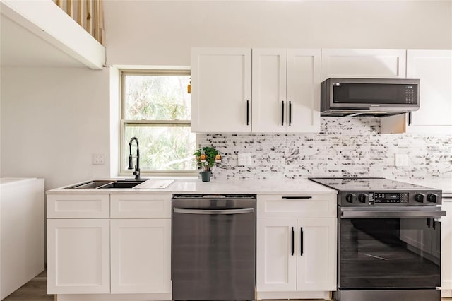 21048 Peachland Blvd, Port Charlotte, FL 33954 - kitchen with stainless steel appliances, a sink, and white cabinetry
