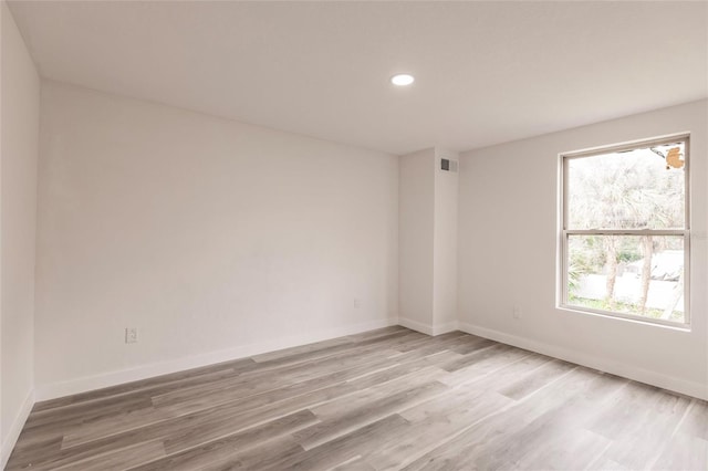 unfurnished room with a wealth of natural light and wood-type flooring