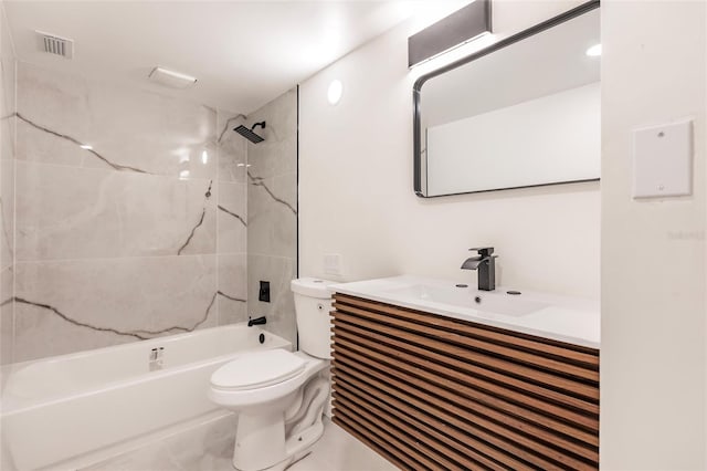 full bathroom featuring toilet, vanity, and tiled shower / bath