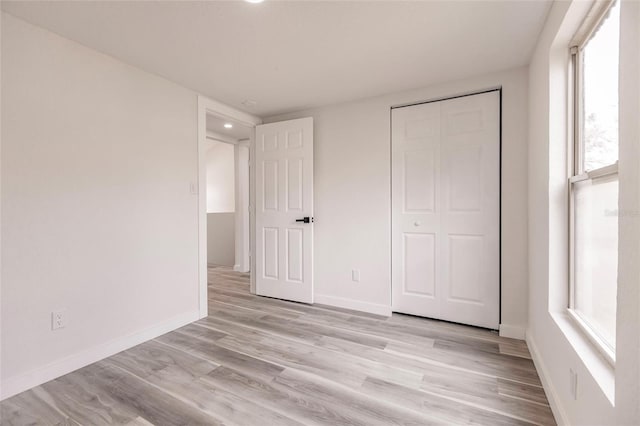 21048 Peachland Blvd, Port Charlotte, FL 33954 - unfurnished bedroom with light wood-style flooring, baseboards, a closet, and recessed lighting