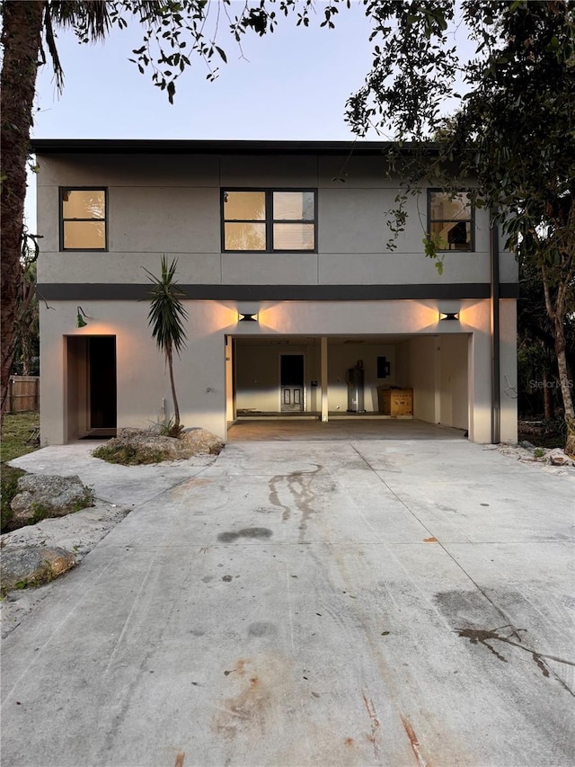 21048 Peachland Blvd, Port Charlotte, FL 33954 - view of front of home with concrete driveway, stucco siding, and a carport