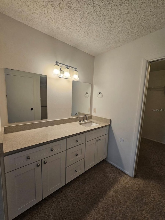 bathroom featuring vanity and a textured ceiling