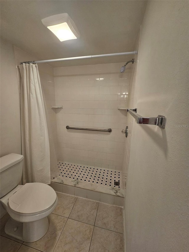 bathroom with walk in shower, tile patterned floors, and toilet