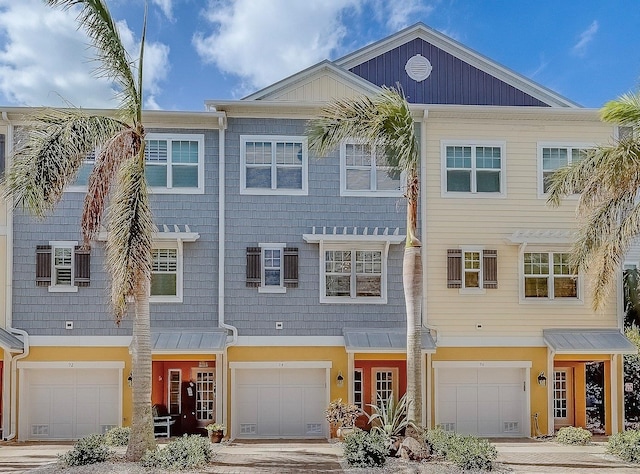 94 The Cove Way, Indian Rocks Beach, FL 33785 - townhome / multi-family property featuring an attached garage and driveway