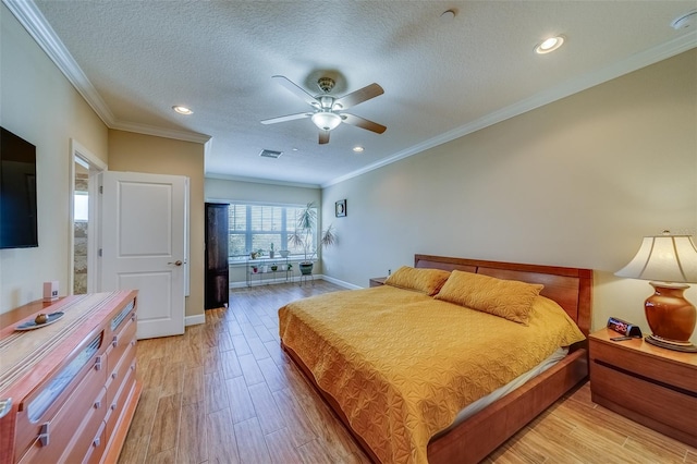 bedroom with a textured ceiling, light hardwood / wood-style floors, ceiling fan, and crown molding