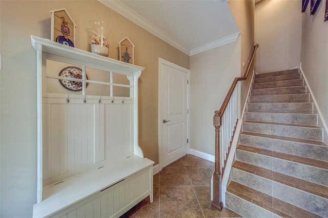 mudroom featuring tile patterned flooring and crown molding