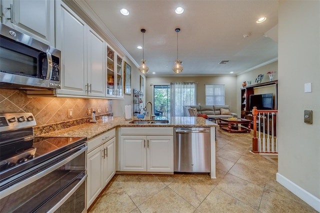 94 The Cove Way, Indian Rocks Beach, FL 33785 - kitchen with stainless steel appliances, a sink, a peninsula, ornamental molding, and tasteful backsplash