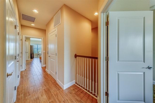 94 The Cove Way, Indian Rocks Beach, FL 33785 - hallway featuring baseboards, light wood-type flooring, and recessed lighting