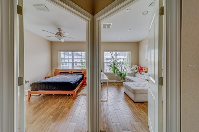 94 The Cove Way, Indian Rocks Beach, FL 33785 - bedroom with light wood finished floors, baseboards, and ceiling fan