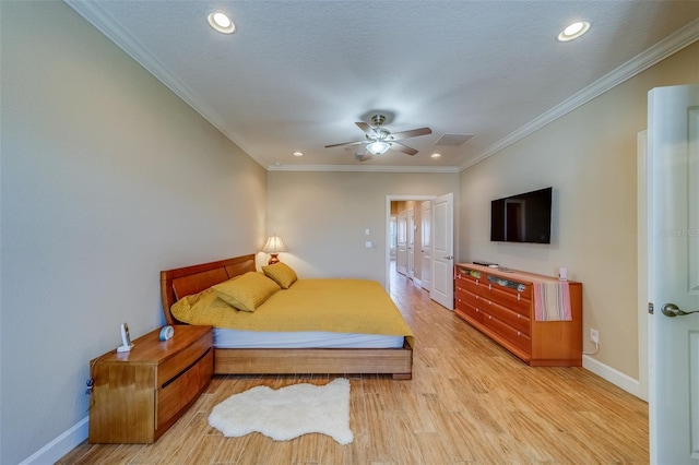 bedroom with ceiling fan, crown molding, a textured ceiling, and light wood-type flooring