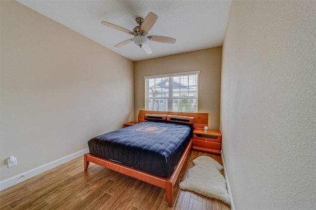 bedroom with ceiling fan and hardwood / wood-style floors