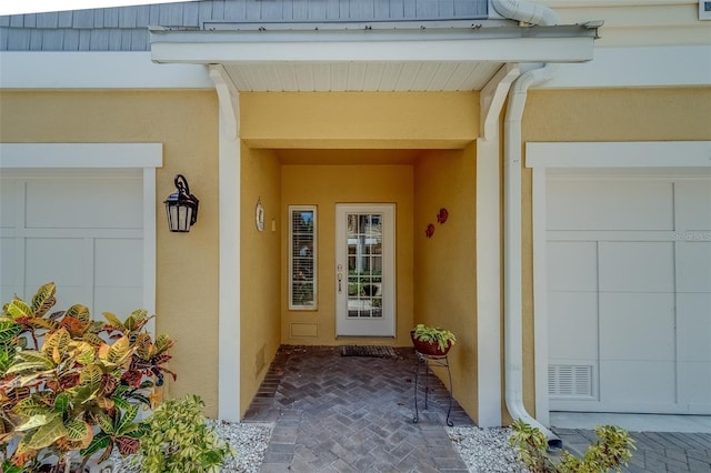 94 The Cove Way, Indian Rocks Beach, FL 33785 - doorway to property with stucco siding