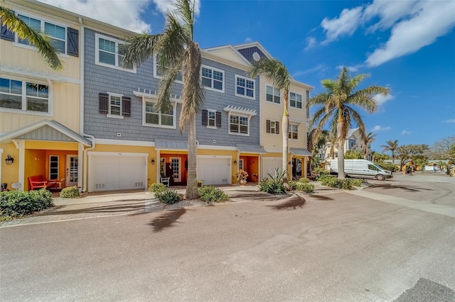 94 The Cove Way, Indian Rocks Beach, FL 33785 - multi unit property featuring an attached garage, driveway, and a residential view