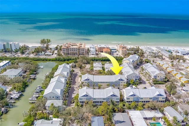 bird's eye view featuring a water view and a view of the beach