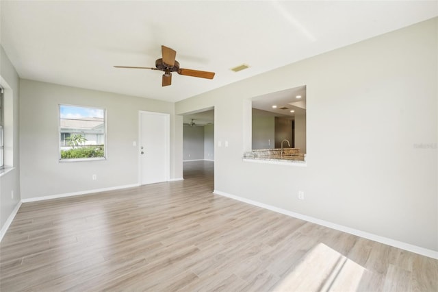 spare room with ceiling fan and light hardwood / wood-style flooring