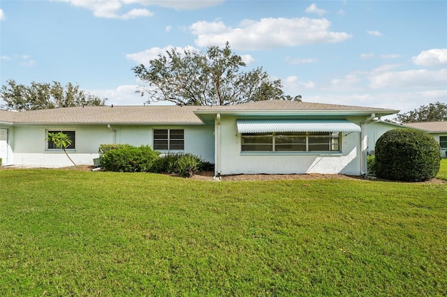 back of property featuring a lawn