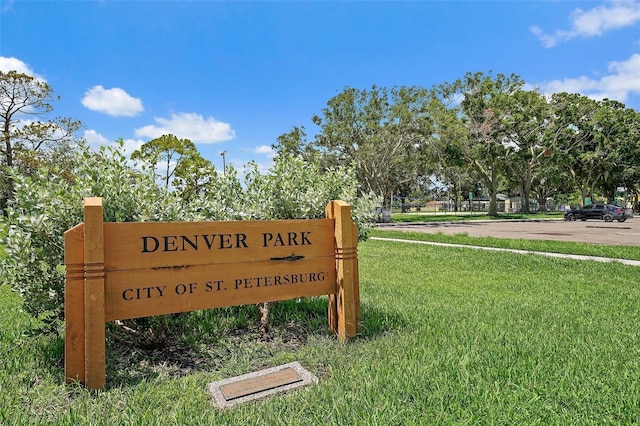 community / neighborhood sign with a yard