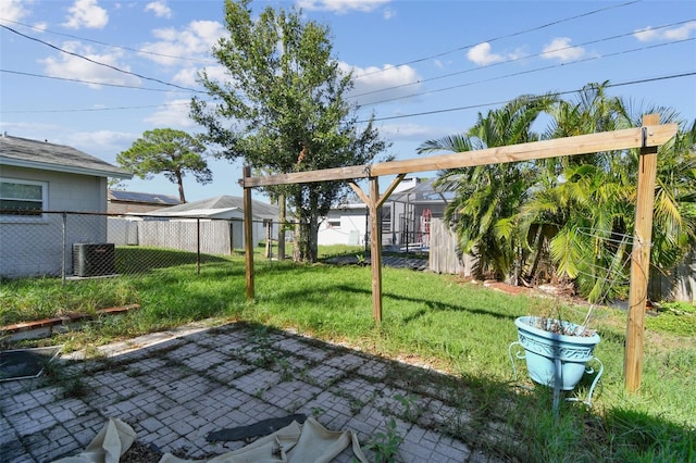 view of yard featuring central air condition unit and a patio