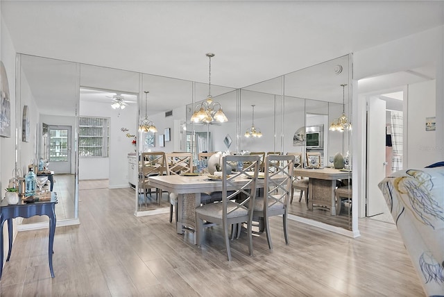 dining area with ceiling fan and light hardwood / wood-style flooring