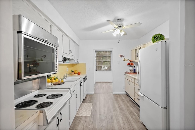 kitchen featuring a textured ceiling, white appliances, sink, light hardwood / wood-style flooring, and white cabinets