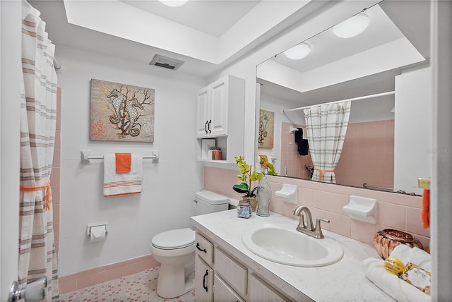 bathroom featuring toilet, vanity, tile patterned floors, and walk in shower