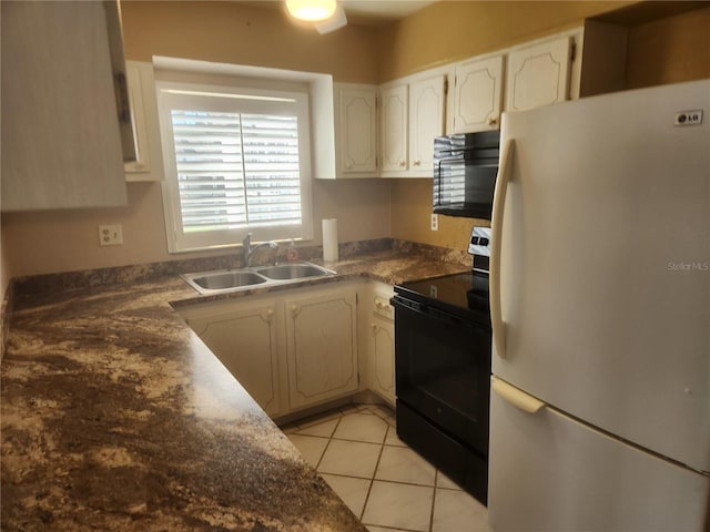 kitchen featuring black appliances, sink, and light tile patterned floors