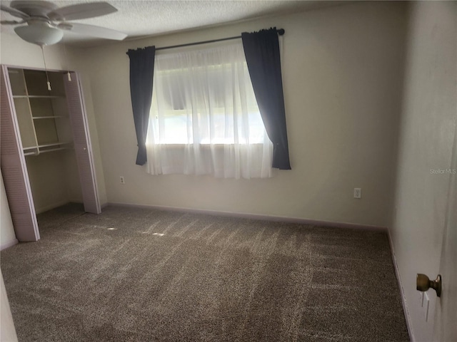 unfurnished bedroom with carpet flooring, a textured ceiling, ceiling fan, and a closet