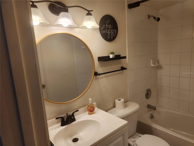 full bathroom featuring tiled shower / bath, toilet, and vanity