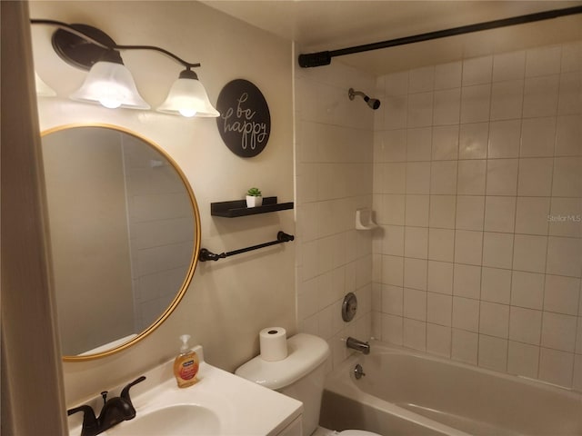 full bathroom with vanity, tiled shower / bath, and toilet