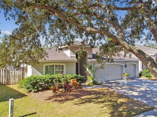 view of front of home featuring a garage and a front lawn