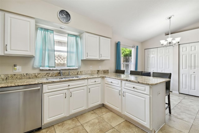 kitchen with dishwasher, kitchen peninsula, white cabinets, and lofted ceiling