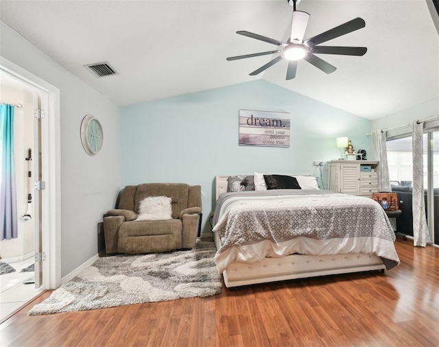 bedroom featuring hardwood / wood-style floors, ceiling fan, and vaulted ceiling