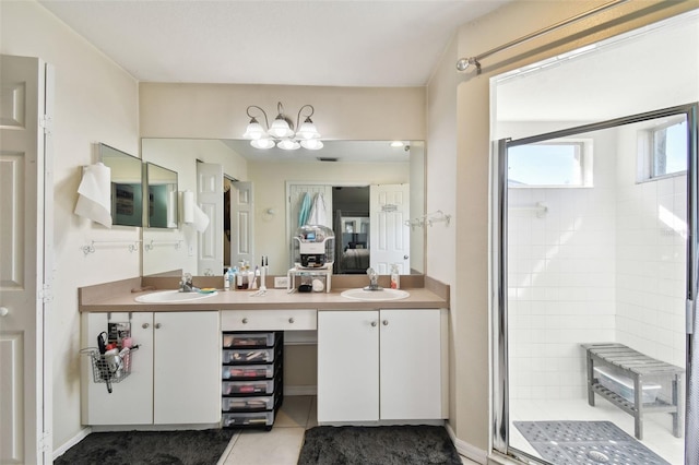 bathroom featuring tile patterned flooring, vanity, and an enclosed shower