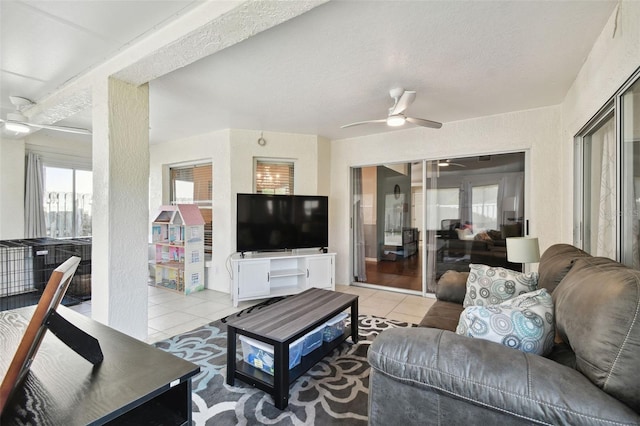 tiled living room featuring ceiling fan and a textured ceiling