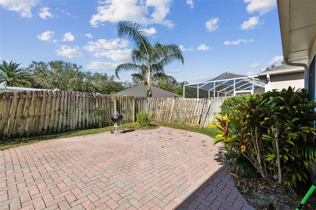 view of patio / terrace featuring a lanai